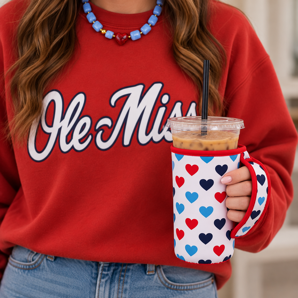 Ole Miss game day look with red sweatshirt, beaded necklace, and handled drink sleeve
