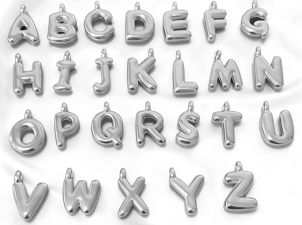 Silver puffy initial pendant charms, letters A through Z, on a white background