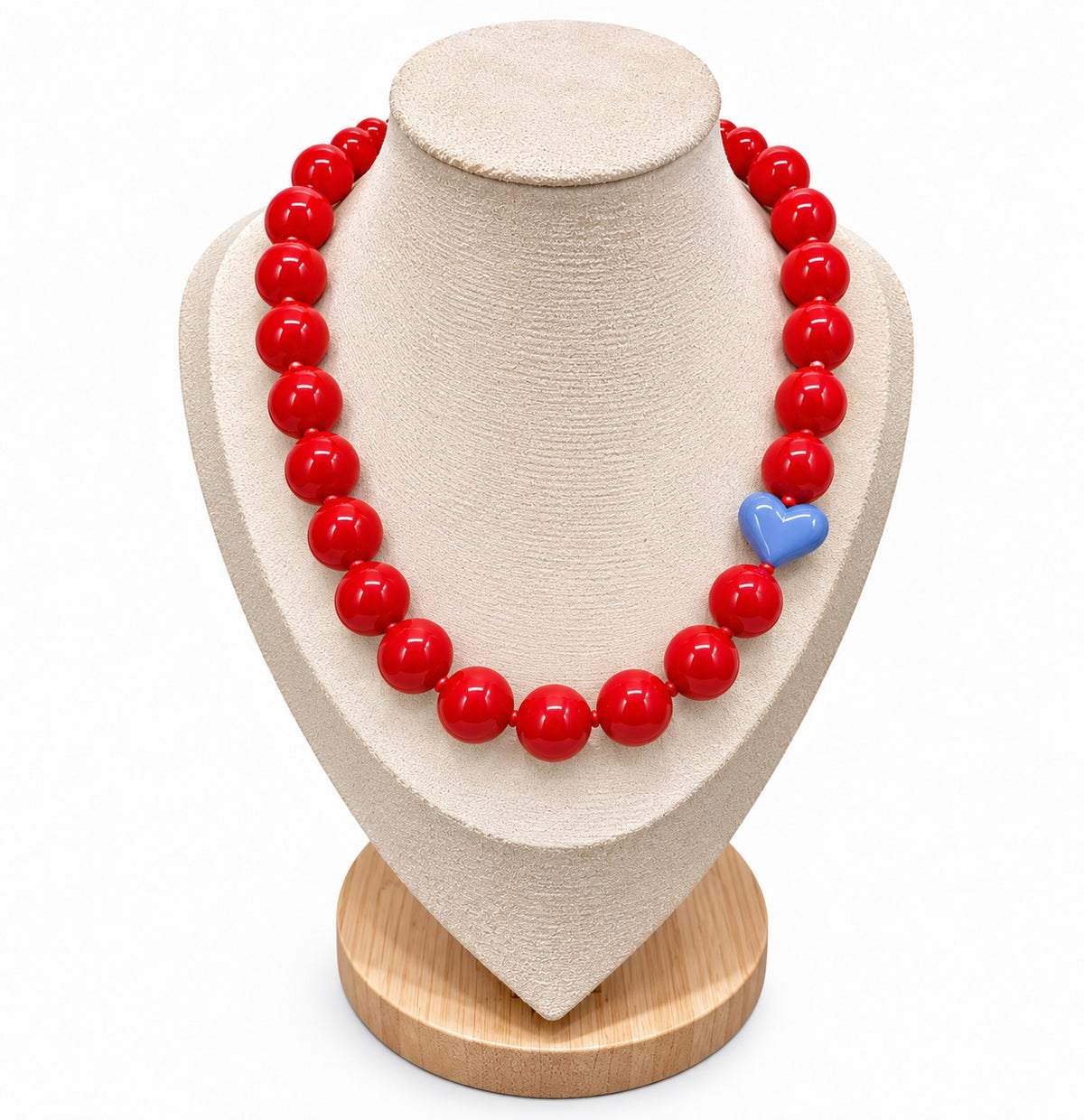 Red beaded necklace with powder blue heart accent on jewelry display